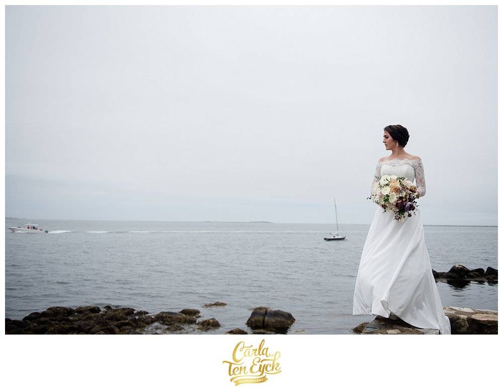Branford House wedding bride stands by the water on her wedding day
