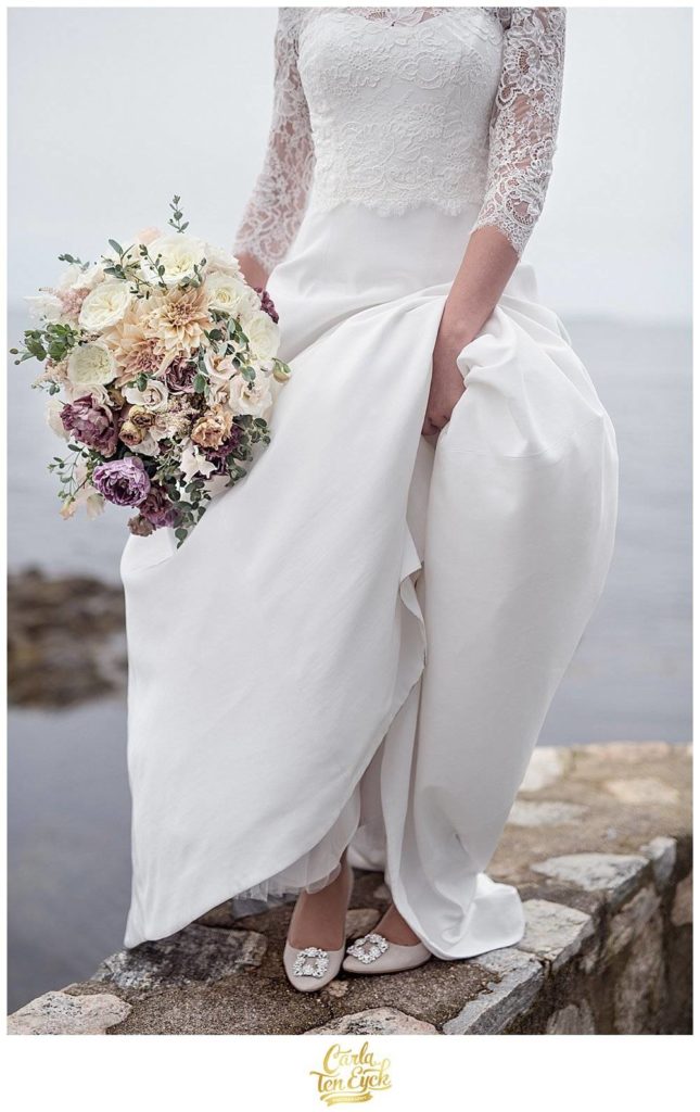 A bride stands at the water at the Branford House in Groton CT