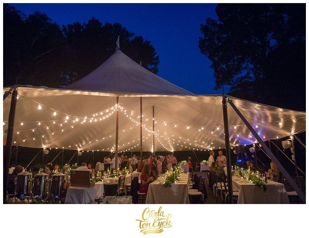 backyard tented wedding lit up at night
