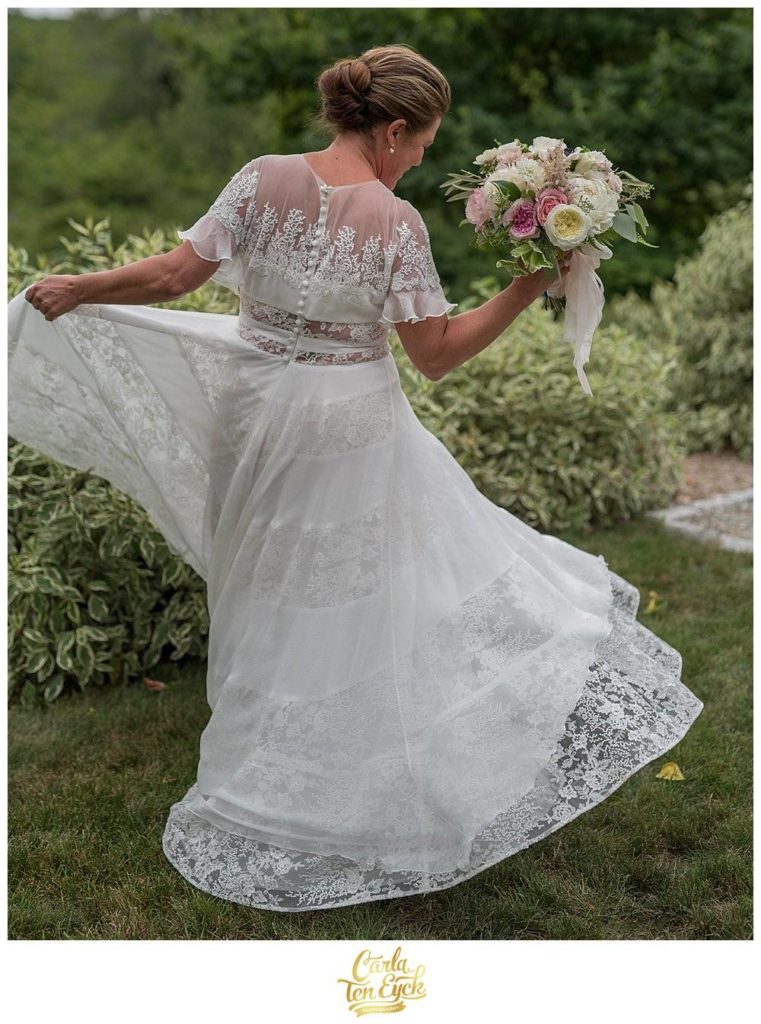 Bride in her Rivini wedding gown holding wedding bouquet with garden roses at Harkness Park, Waterford CT