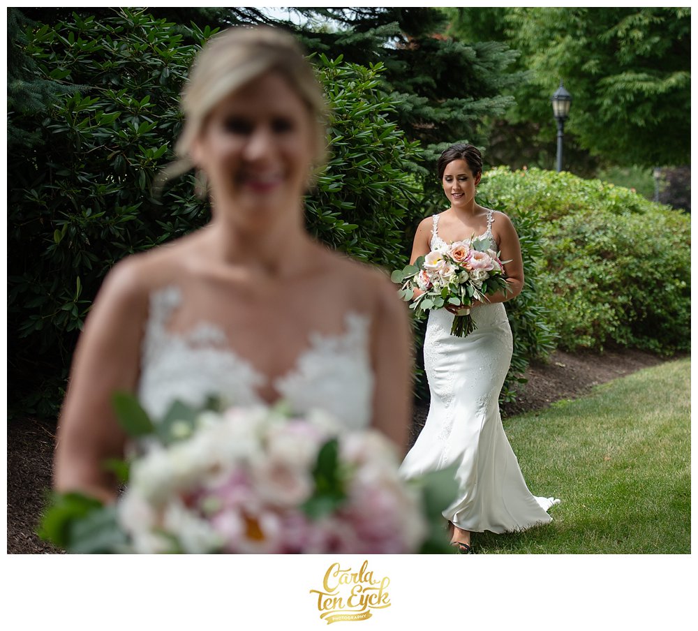 Two brides at their first look on their wedding day at Jonathan Edwards Winery North Stonington CT