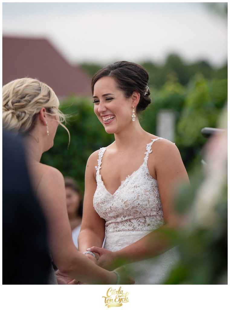 Two brides laugh at their wedding ceremony at Jonathan Edwards Winery North Stonington CT
