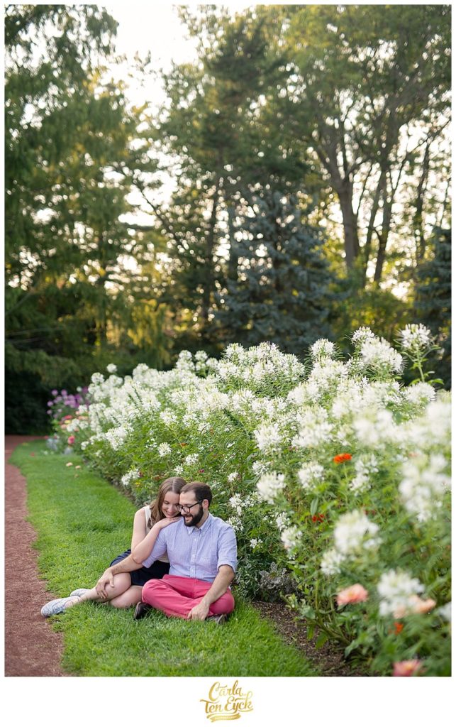 Couple snuggling at their engagement session in Hartford's Elizabeth Park