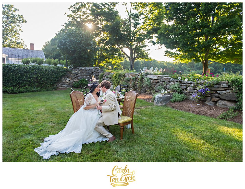 A bride and groom toast champagne at their wedding at Smith Farm Garden in East Haddam CT