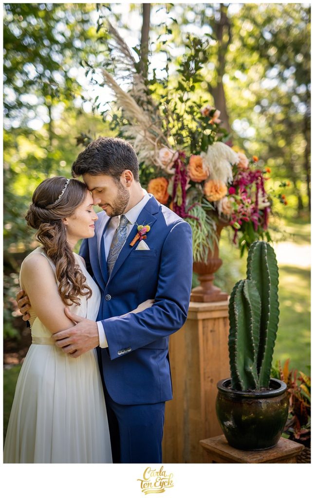 Bride and groom hugging by cactus on their wedding day in Norwalk CT