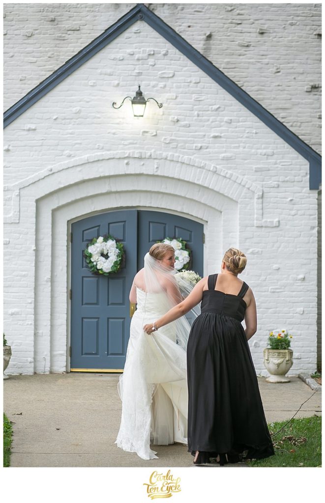 Bride enters the church with her bridesmaid on her wedding day in Lordship CT