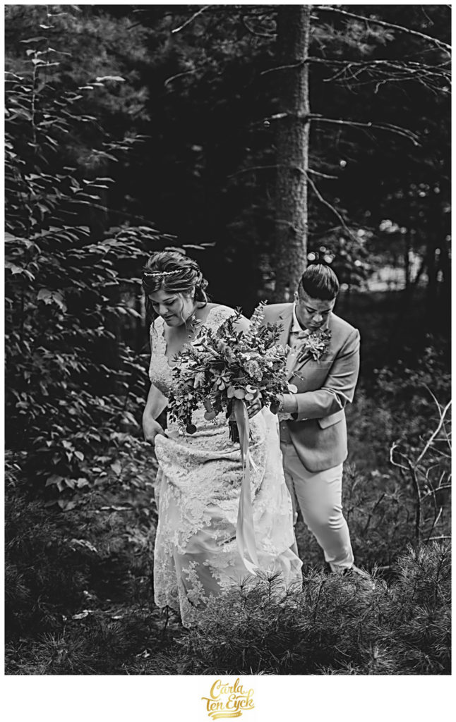 Two brides walk in the woods on their wedding day in Glastonbury CT