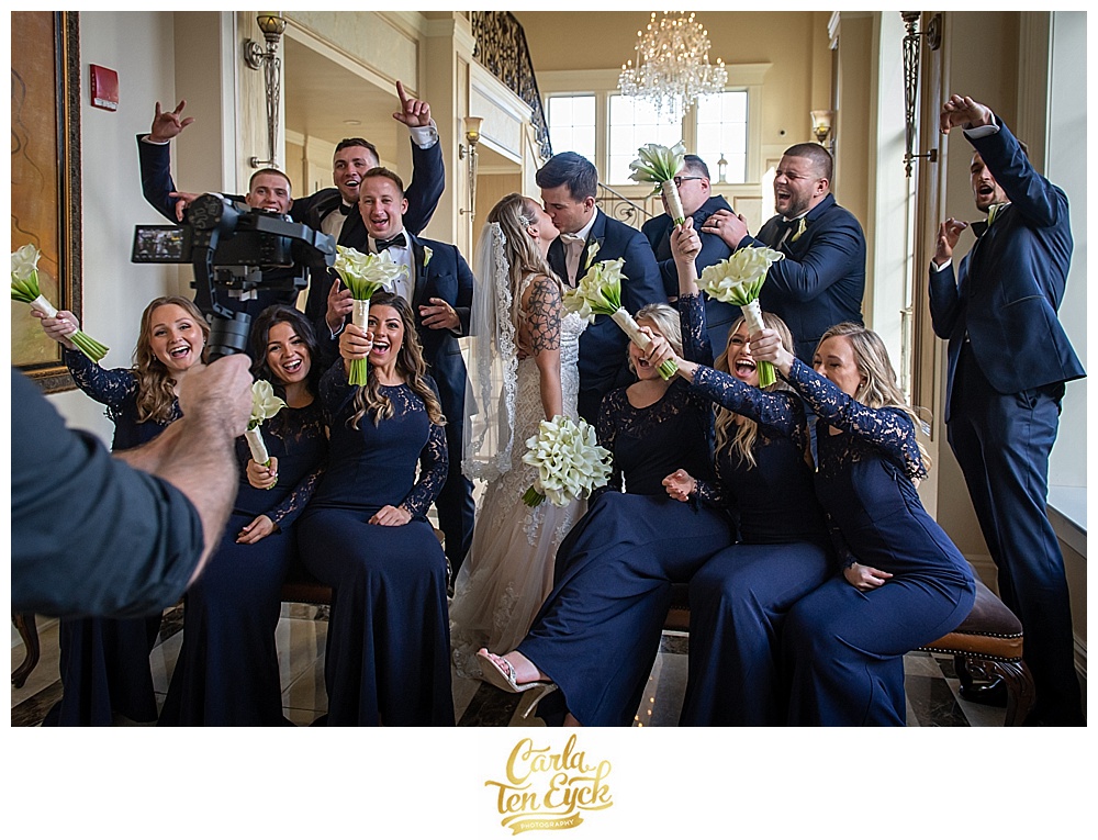 Bridesmaids in Lulus navy bridesmaids gowns laugh and yell at wedding at Aria in Prospect CT