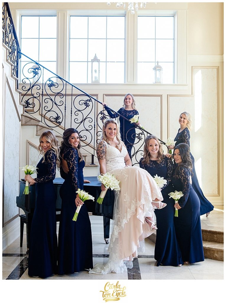 Bride in Stella York wedding gown with her navy bridesmaids at Aria in Prospect CT