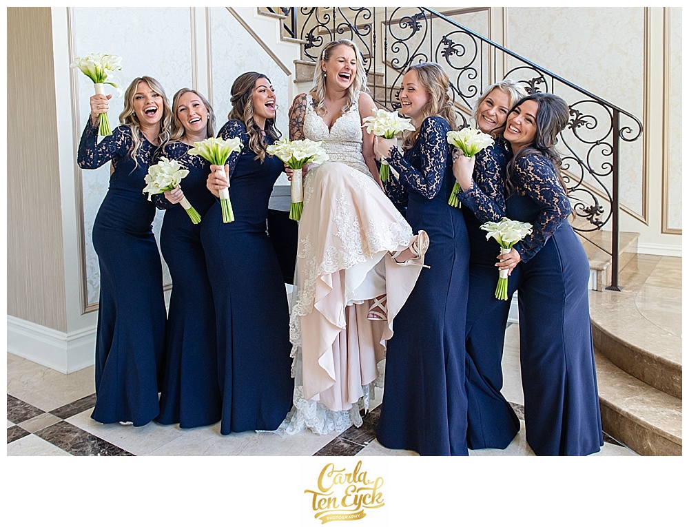 Bride in Stella York wedding gown with her navy bridesmaids dresses and calla lily bouquets at Aria in Prospect CT