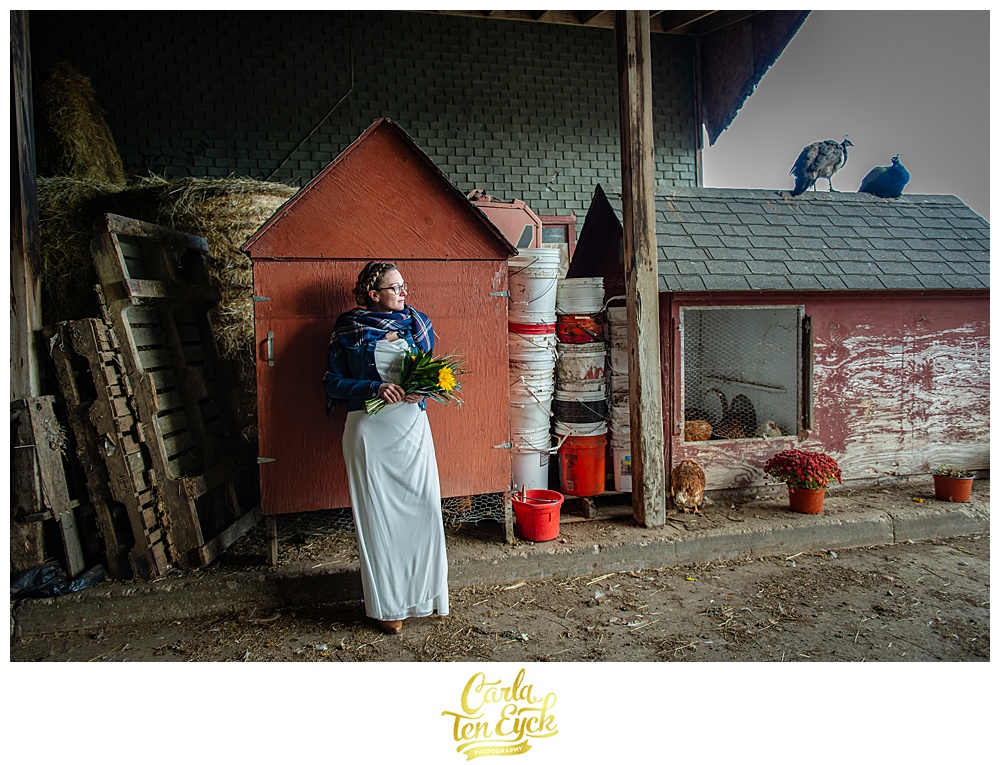 Bride stands in a barn on their wedding at Cold Spring Farm in Colchester CT