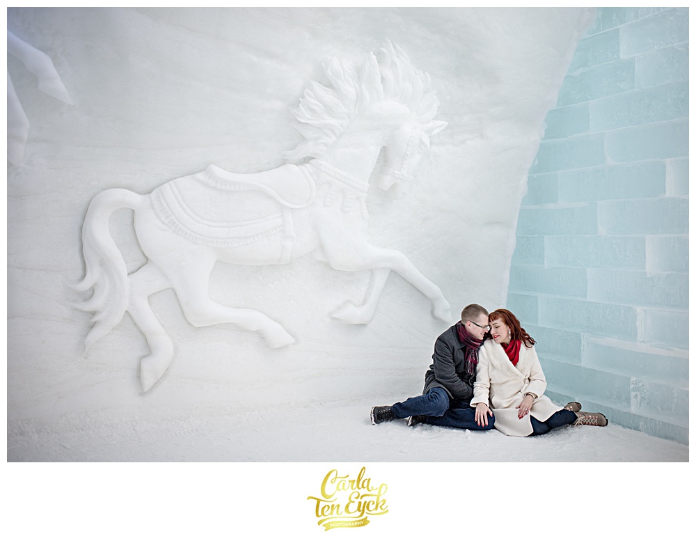 Couple snuggles at the ice hotel de Glace in Montreal Canada