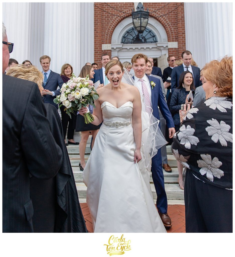 Bride and groom leave the church joyously at their wedding at Le Chateau in South Salem NY