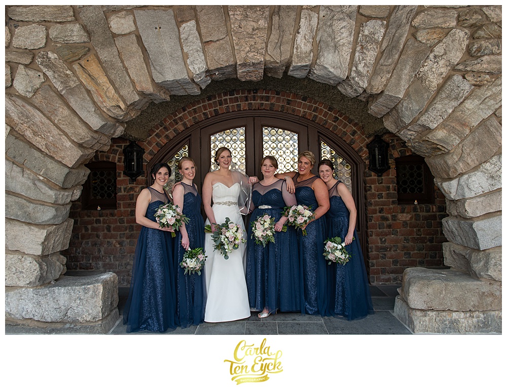 Bride with bridesmaids in navy sequin bridesmaids dresses at Le Chateau in South Salem NY