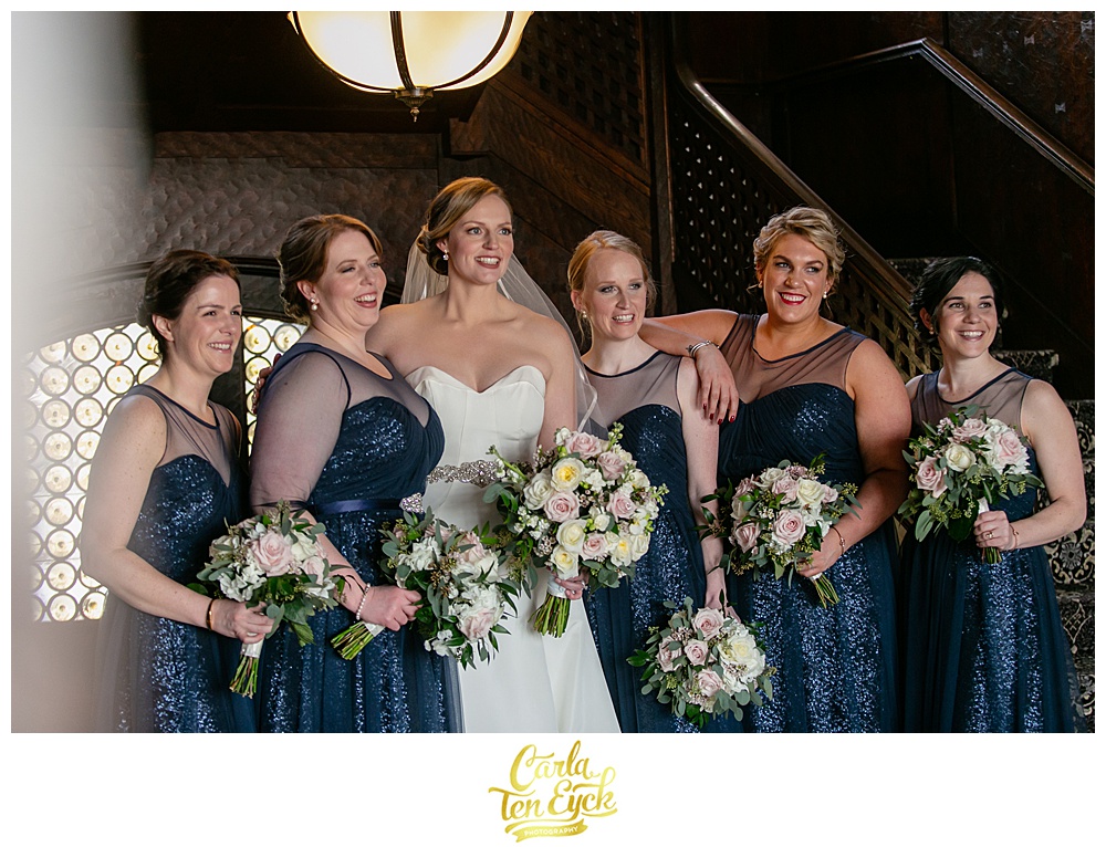 Bride in Antonio Gaul wedding gown and bridesmaids in navy sequin bridesmaids dresses at Le Chateau in South Salem NY