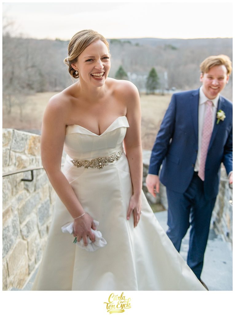 Bride laughs in her Antonio Gaul wedding gown at her wedding at Le Chateau in South Salem NY