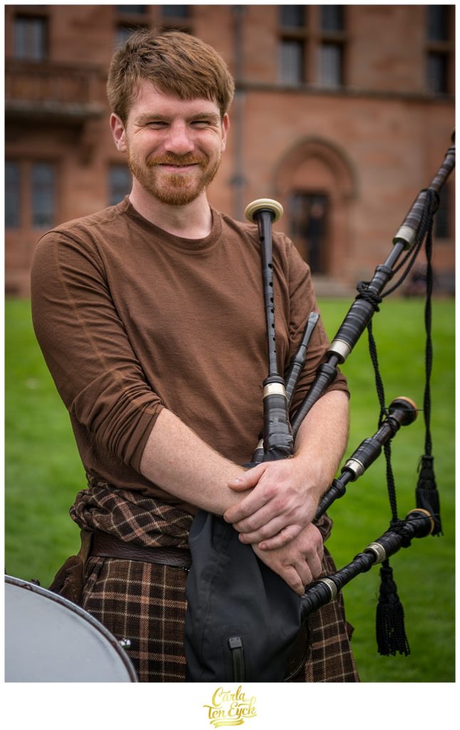 Red headed Scottish bagpiper at Mount Stuart Castle on the Isle of Bute Scotland