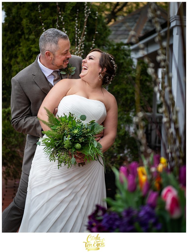 Groom cuddles his happy bride in her plus size wedding gown from David's Bridal at the Publick House in Sturbridge MA