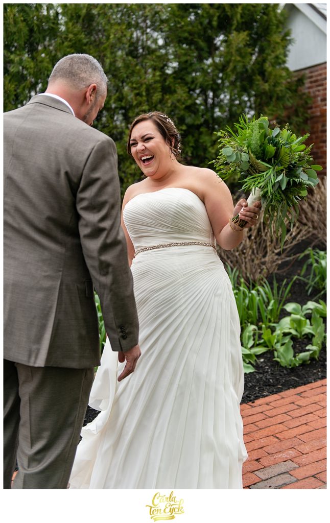 A bride happily reacts to her first look at her wedding at the Publick House in Sturbridge MA