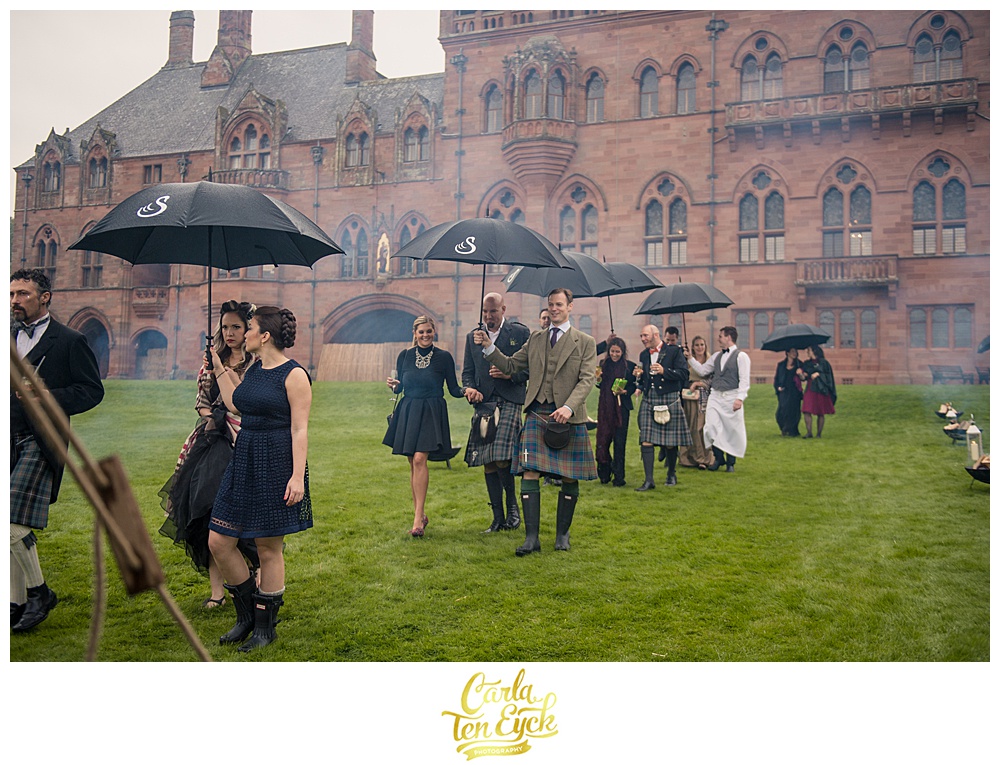 Guests arrive at a rainy wedding at Mount Stuart on the Isle of Bute Scotland 