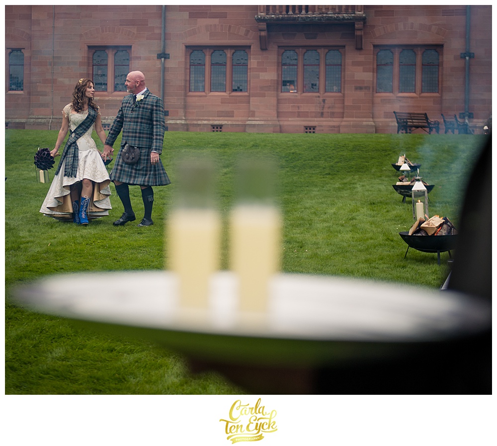 Bride and groom in Scottish outfits arrive at their wedding in Scotland at Mount Stuart