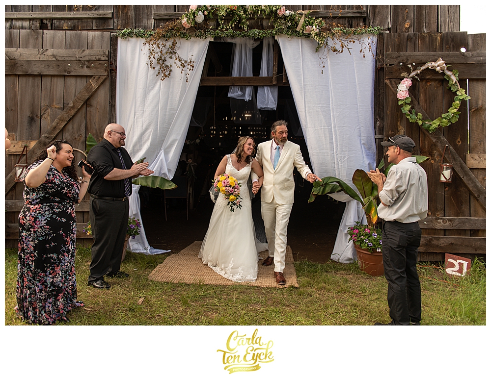 Happy bride and groom just married at their tobacco barn backyard wedding in CT