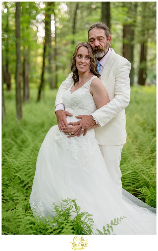 Bride and groom in a fern grove in CT