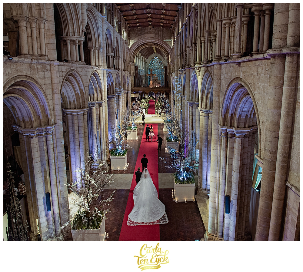 Bride walks down the aisle at her wedding at Selby Abbey Yorkshire UK
