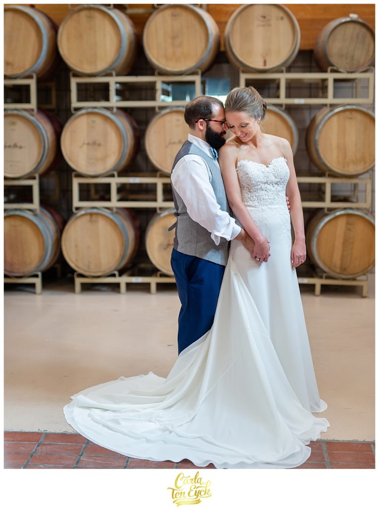 Bride and groom in the barrel room at Jonathan Edwards Winery for their wedding in North Stonington CT