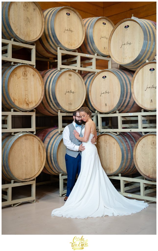 Bride and groom in the barrel room at Jonathan Edwards Winery for their wedding in North Stonington CT
