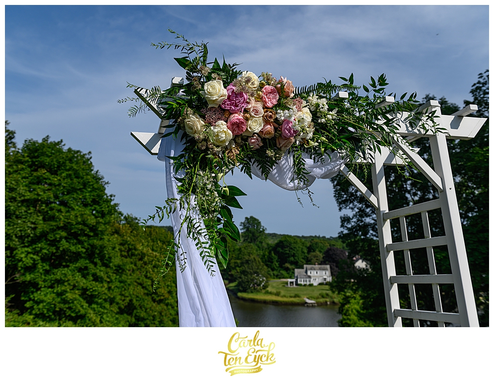 Floral wedding arbor by Ladybug Designs at the Inn at Mystic, in Mystic CT
