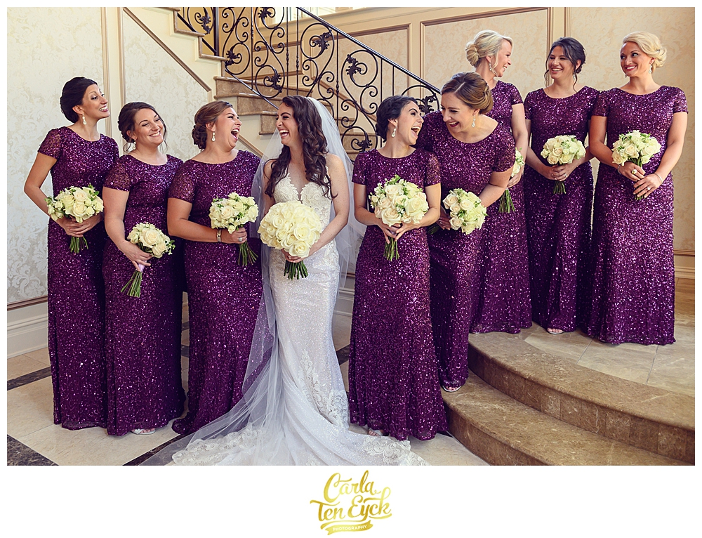 A bridal party in sequin purple gowns laugh with their bride at her wedding at Aria in Prospect CT
