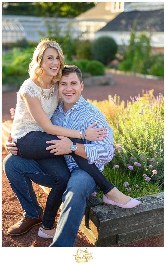 A couple snuggles in the herb garden in Elizabeth Park during their CT engagement session in Hartford CT