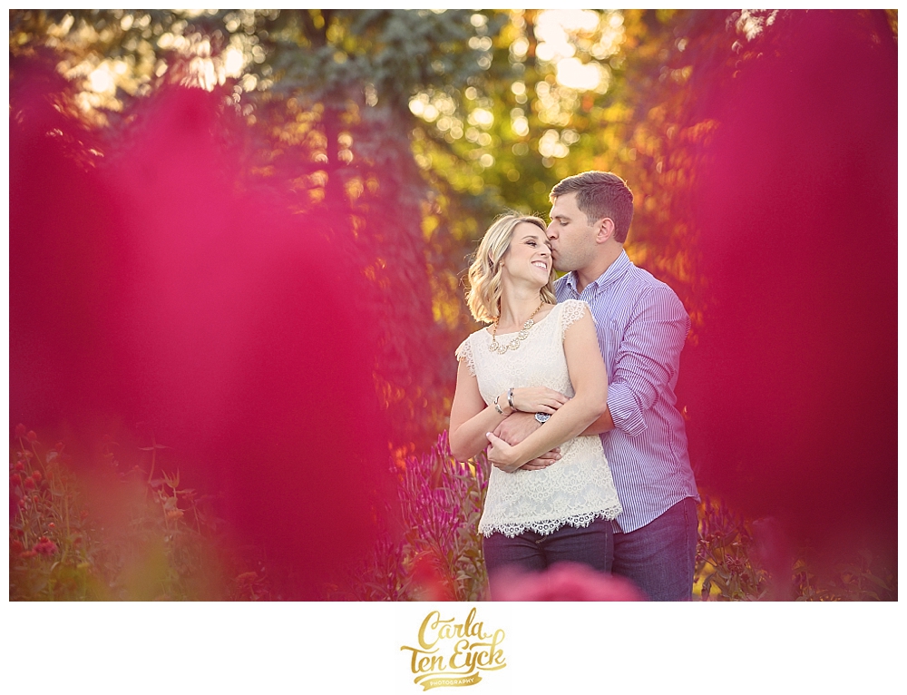 A couple embraces in the annual garden at Elizabeth Park during their CT engagement session in Hartford CT