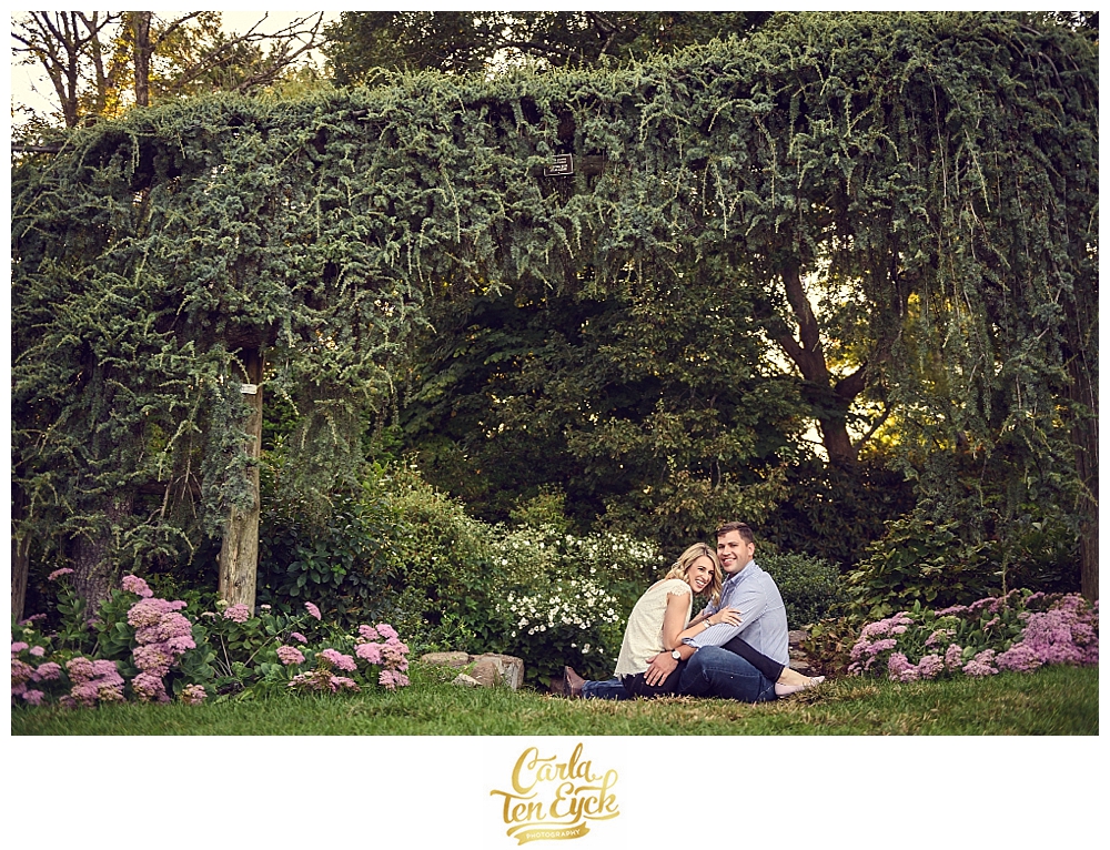 A couple laughs during their CT engagement session in Elizabeth Park in Hartford CT