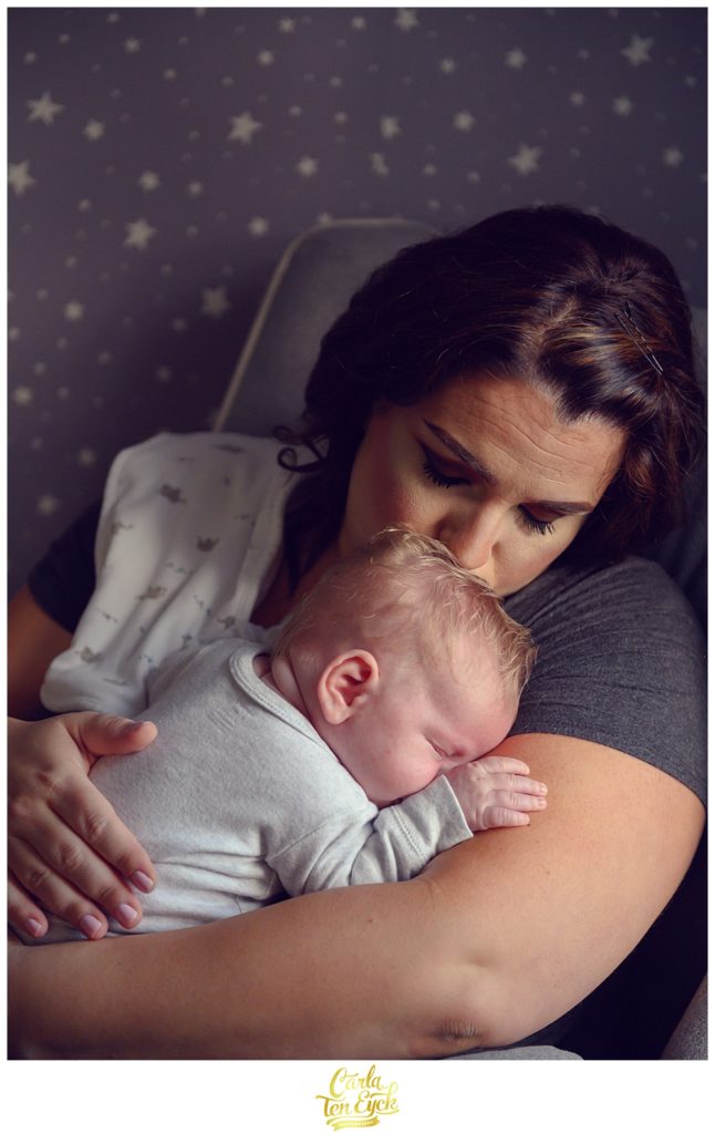 New Mom snuggles her baby boy during their family session in Old Lyme CT