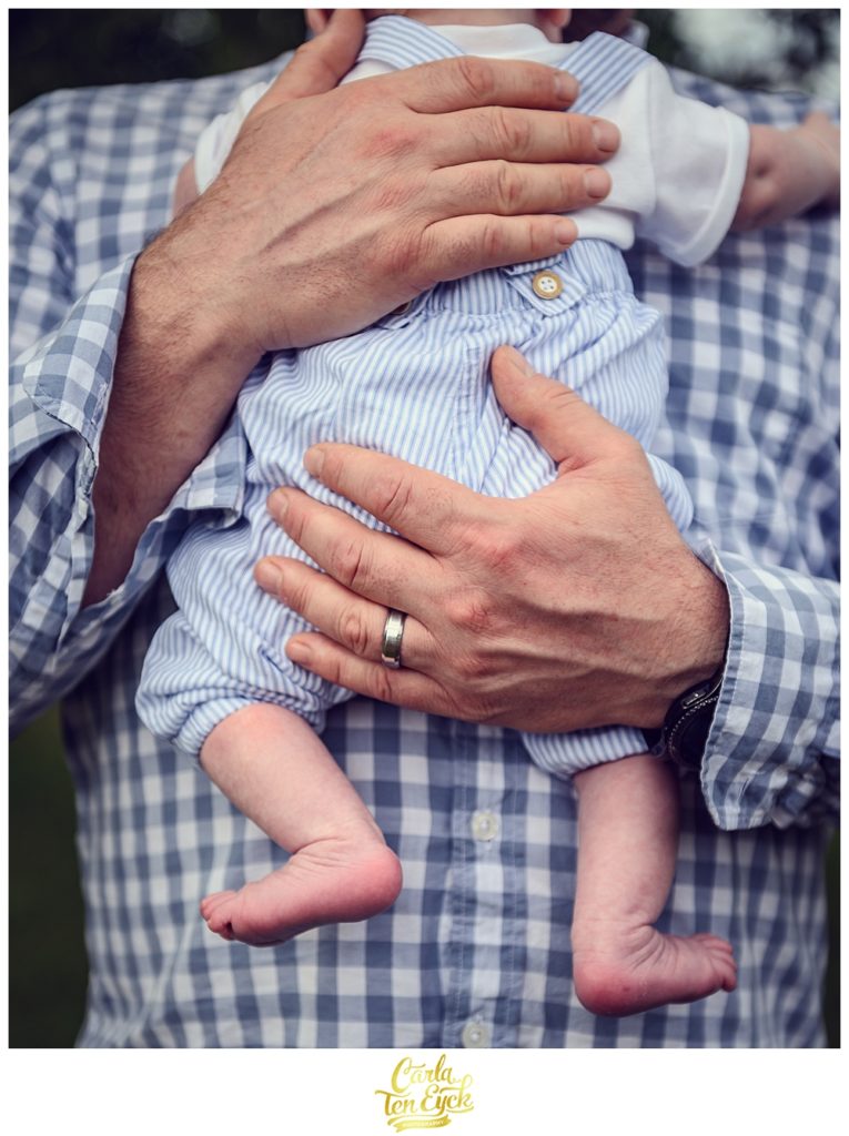 A father holds his newborn son at their home in Old Lyme CT