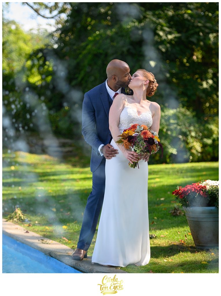 A couple kisses by the fountain at The Spa at Norwich Inn wedding Norwich CT