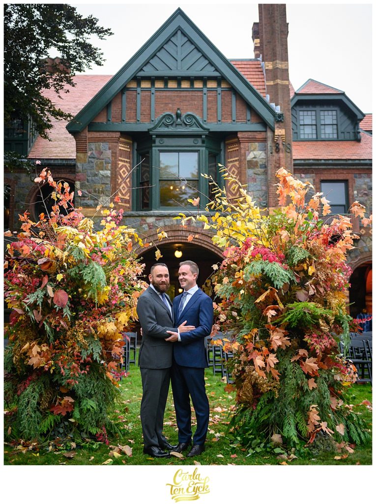 Two grooms laugh at their wedding at the Eustis Estate in Milton MA
