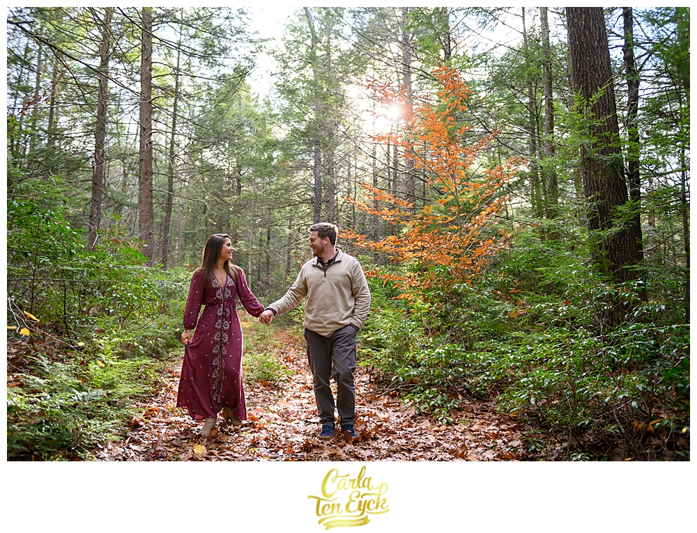 A couple walks through the woods on their engagement session at Valley View Farms in Haydenville MA