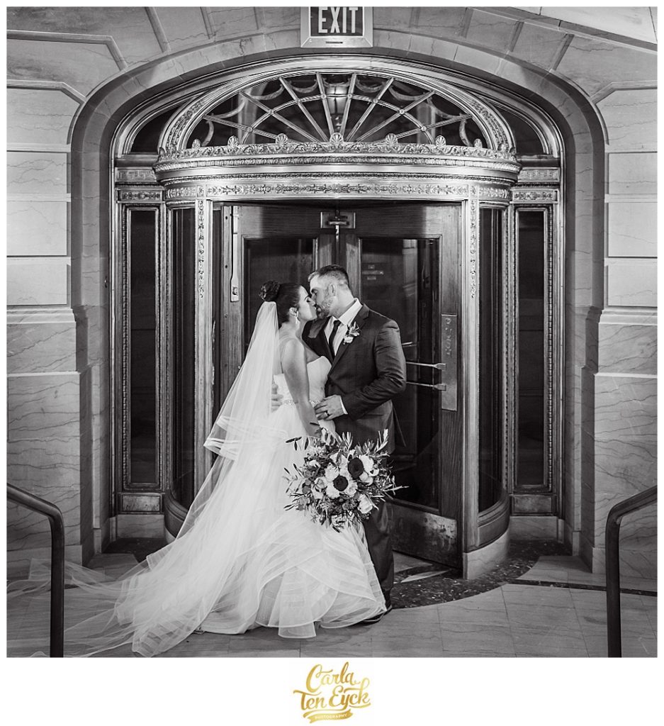 A bride and groom kiss at Hartford City Hall Hartford CT
