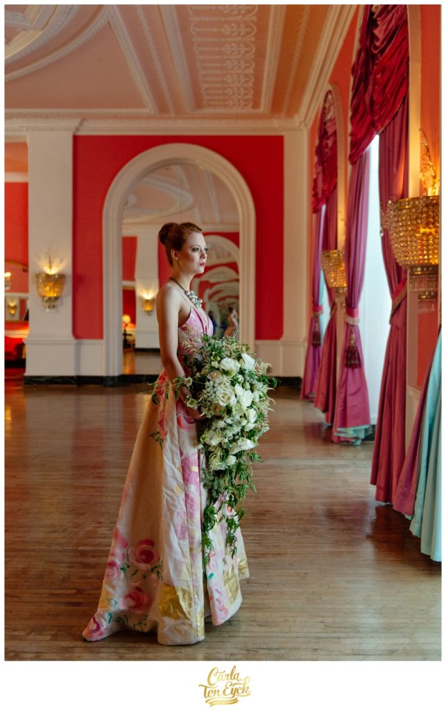 A bride poses in the pink ballroom at The Greenbrier in West Virginia