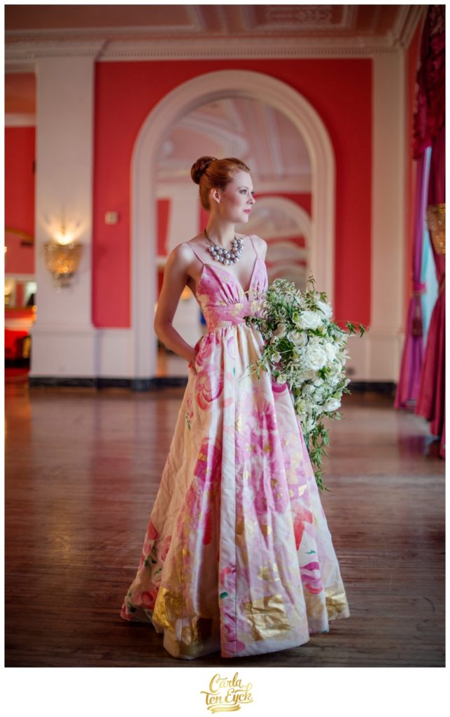 A bride poses in the pink ballroom at The Greenbrier in West Virginia