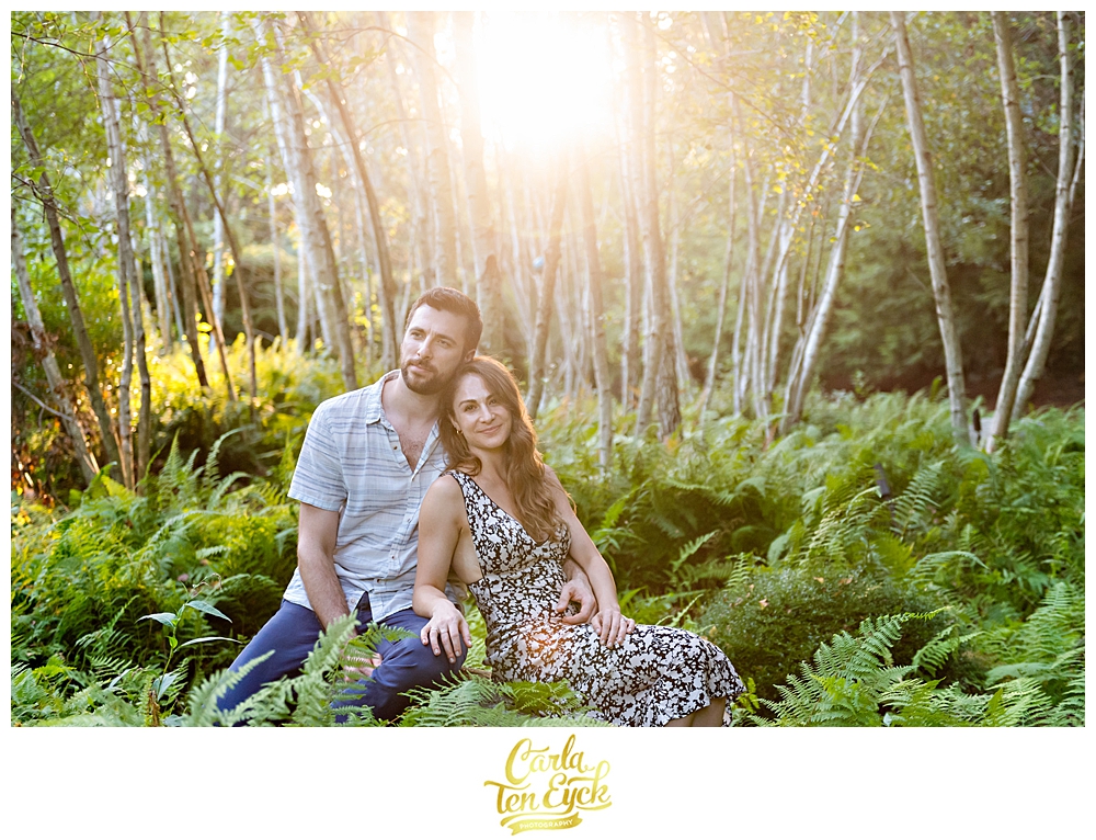 Couple cuddles during their engagement session at Chatfield Hollow Inn in Killingworth CT