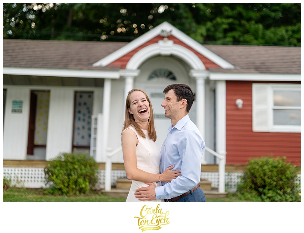 Couple laughs at the beach club at Lake Waramug in New Preston CT during their engagement session