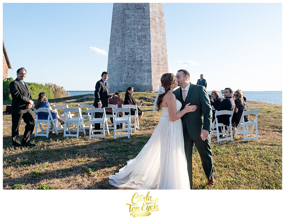 A bride and groom during their wedding ceremony at The Lighthouse at Lighthouse Point Park in New Haven CT 