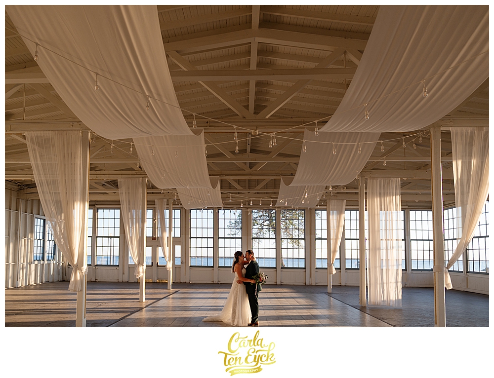 A bride and groom dance in the empty space at Lighthouse Point Park in New Haven CT