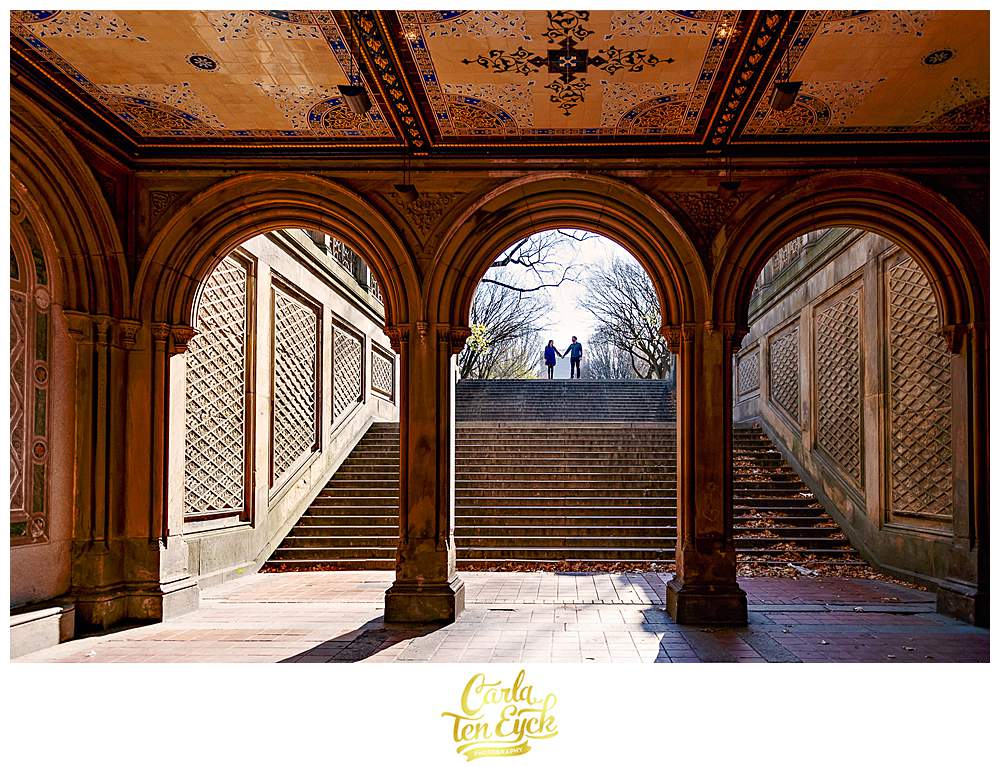A couple poses for photos during their engagement session in an empty Central Park NYC during covid