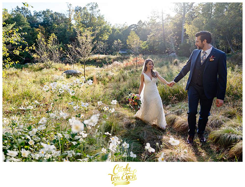 A bride and groom smile in a field during their intimate wedding at The Chatfield Hollow Inn in Killingworth CT