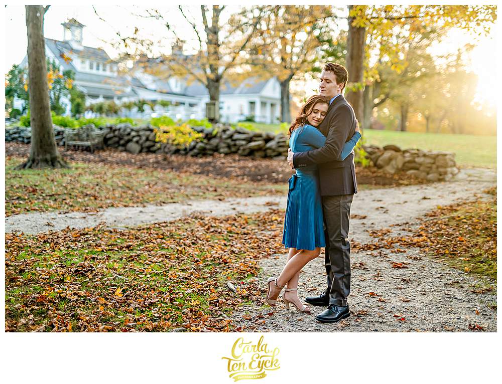 A couple hugs during their engagement session at Smith Farm Gardens in East Haddam CT during golden hour